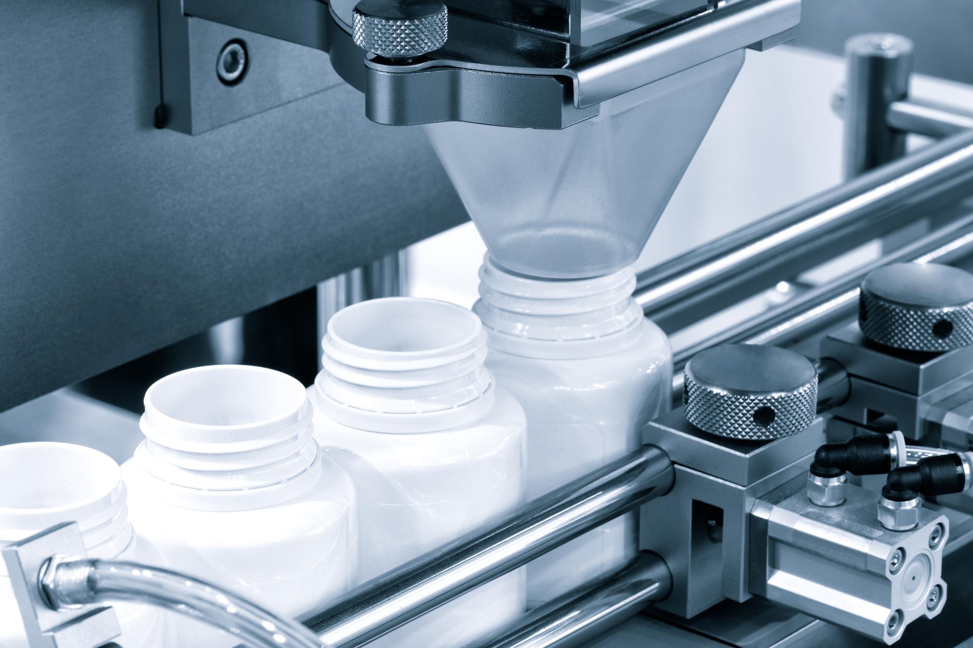 pharmaceutical-industry-medicine-pills-are-filling-bottle-production-line-machine-conveyor-medical-factory-selective-focus_263512-1110